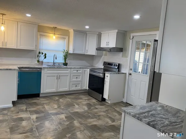 a kitchen with a sink stove and refrigerator