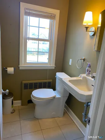 a bathroom with a sink toilet and mirror