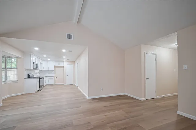 a view of a kitchen with a sink and a window