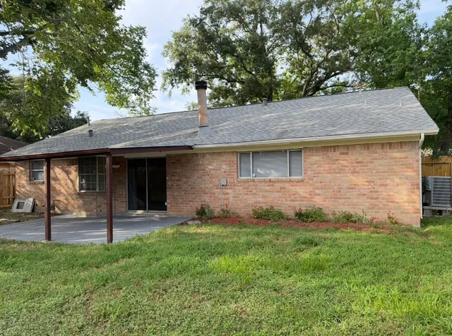 a view of a house with a yard and tree