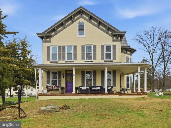 a front view of a building with a garden