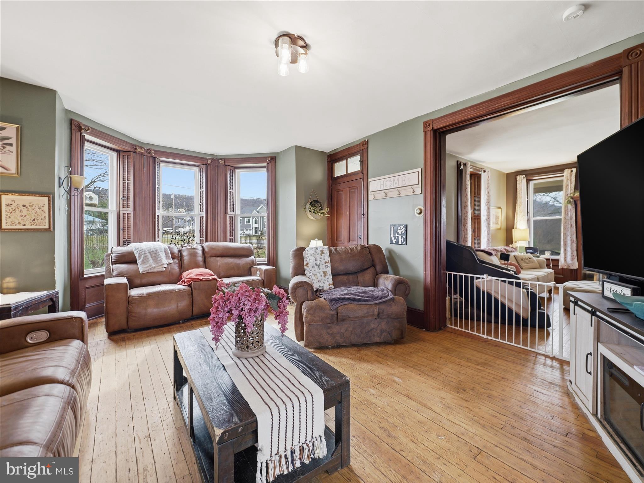 14147 Lower Edgemont Road Waynesboro, PA 17268 - Photo 6 of 45 a living room with furniture a flat screen tv and a large window