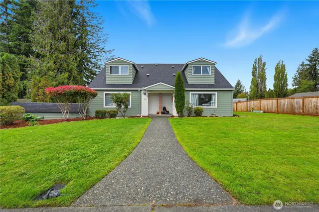 a front view of house with yard and green space