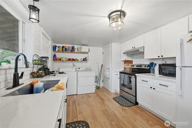 a view of a dining room with furniture a chandelier and wooden floor