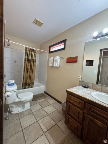 3439 Westwater Road Moab, UT 84532 - Photo 50 of 64 Bathroom with shower / bathtub combination with curtain, vanity, and light tile patterned floors