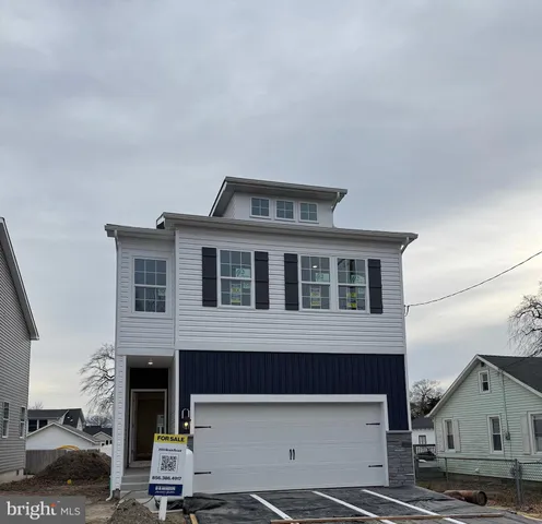 a front view of a house with a street