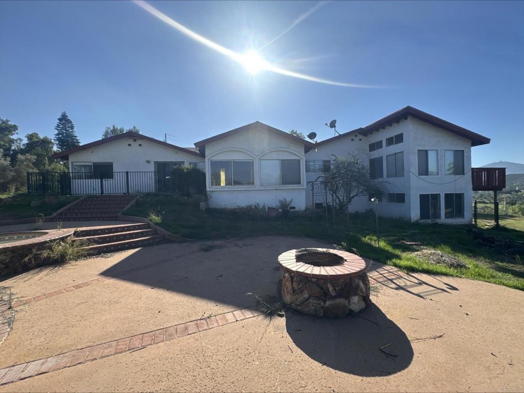 13945 Proctor Valley Road Jamul, CA 91935 - Photo 1 of 1 a view of a house with a yard fire pit and a large tree