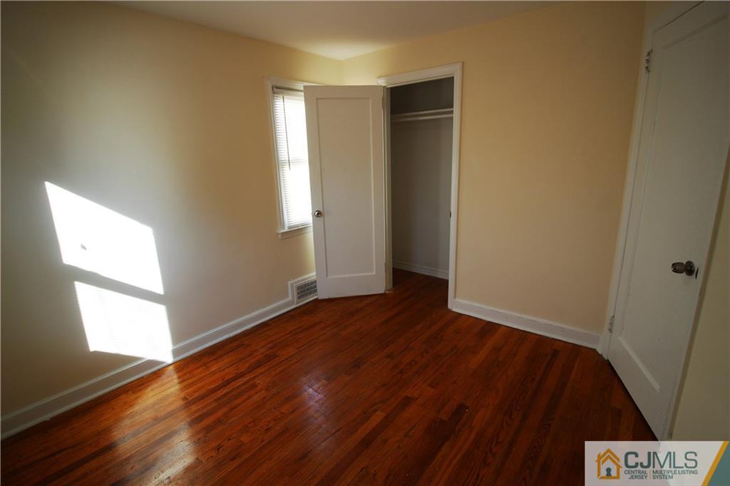 9 MacArthur Drive Edison, NJ 08837 - Photo 13 of 24 an empty room with wooden floor and windows