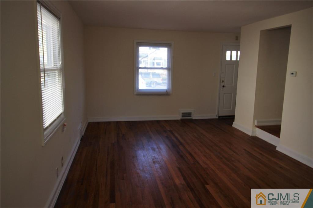 9 MacArthur Drive Edison, NJ 08837 - Photo 15 of 24 a view of an empty room with wooden floor and a window