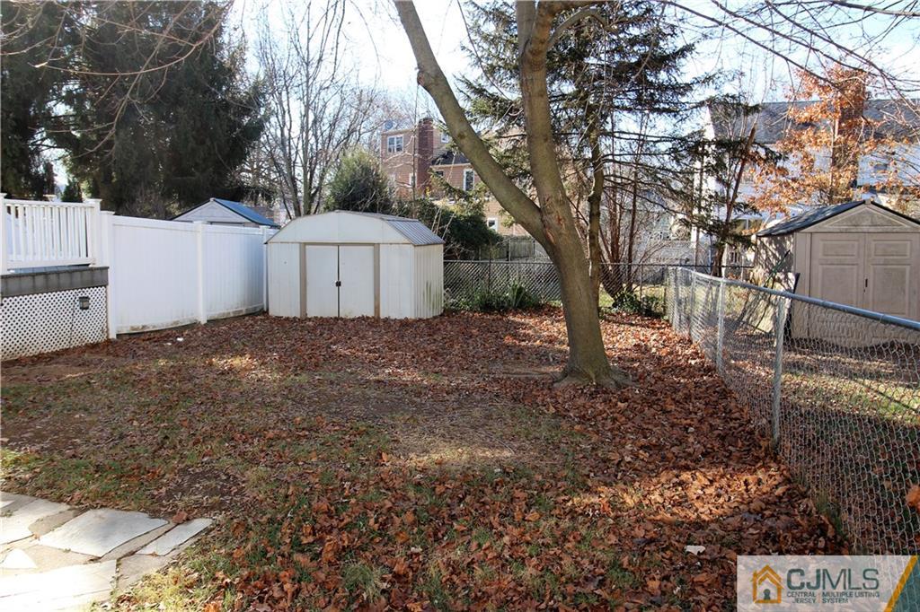 9 MacArthur Drive Edison, NJ 08837 - Photo 20 of 24 a white house that has a tree in front of it