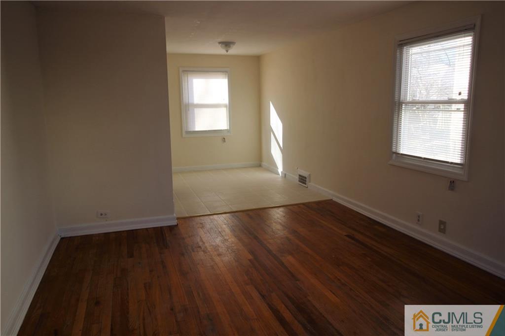 9 MacArthur Drive Edison, NJ 08837 - Photo 4 of 24 an empty room with wooden floor and windows