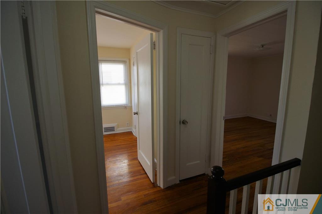 9 MacArthur Drive Edison, NJ 08837 - Photo 6 of 24 a view of hallway with wooden floor