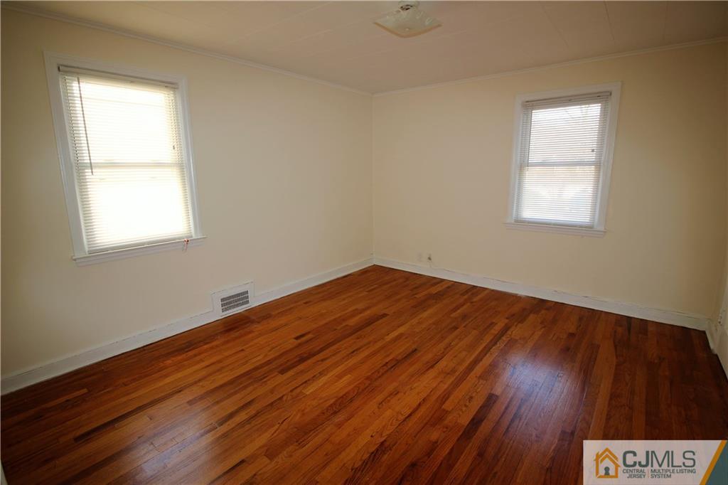 9 MacArthur Drive Edison, NJ 08837 - Photo 9 of 24 an empty room with wooden floor and windows