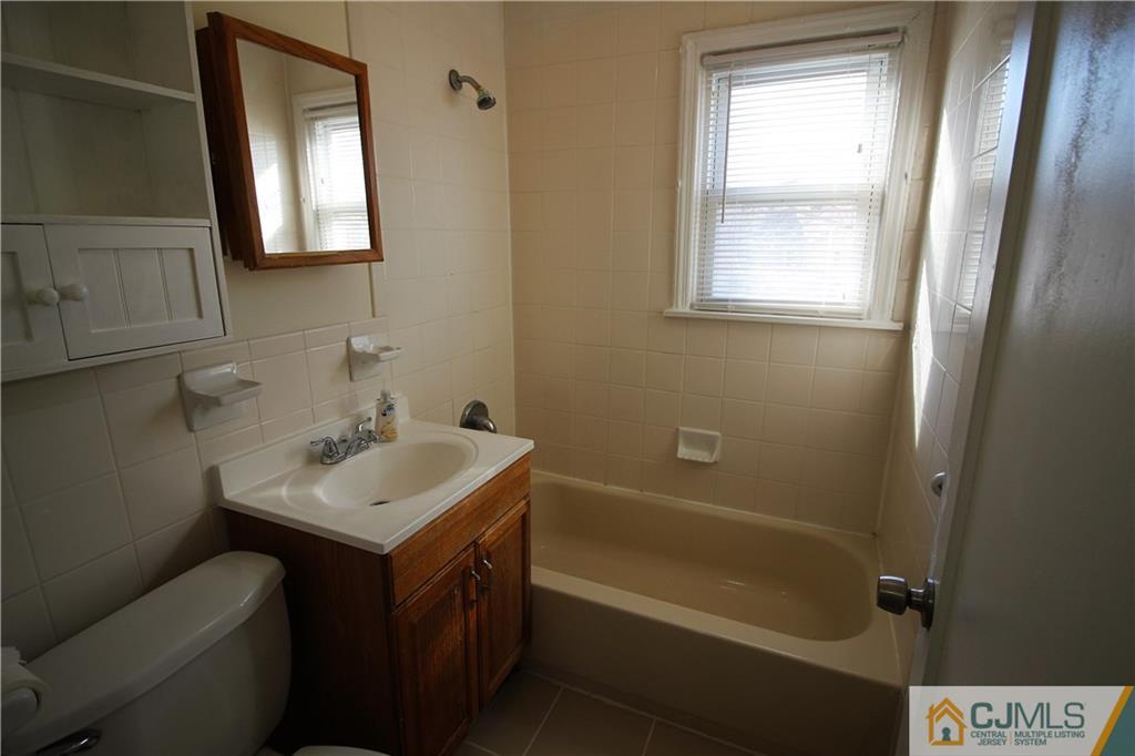 9 MacArthur Drive Edison, NJ 08837 - Photo 10 of 24 a bathroom with a sink toilet vanity and tub
