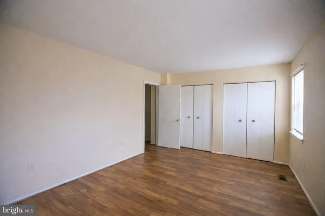 a view of hallway with wooden floor
