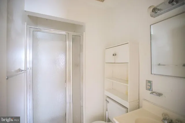a bathroom with a toilet mirror and vanity