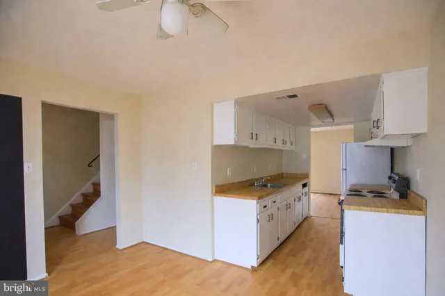 a kitchen with granite countertop a sink a stove and dishwasher