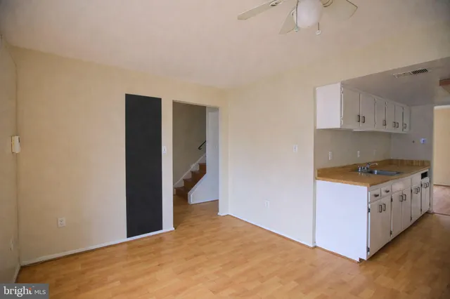 a kitchen with stainless steel appliances white cabinets and a sink