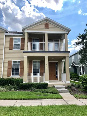 a view of brick house with a yard