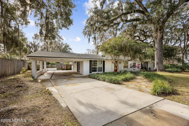 a view of a house with a yard and sitting area