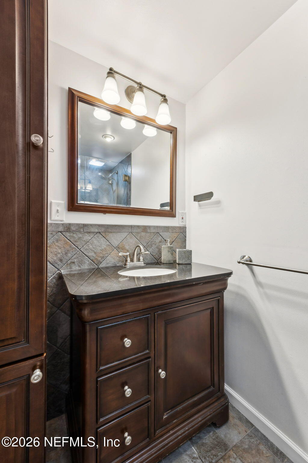 3648 Rubin Road Jacksonville, FL 32257 - Photo 23 of 49 a bathroom with a granite countertop sink and mirror