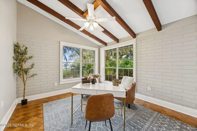 a dining room with furniture and a floor to ceiling window