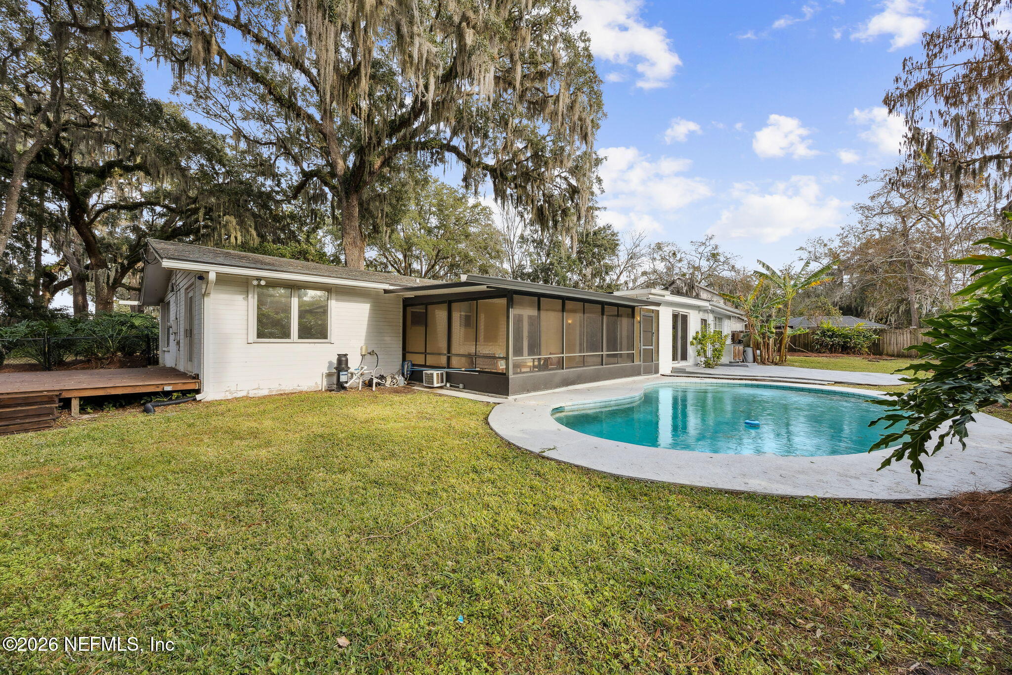 3648 Rubin Road Jacksonville, FL 32257 - Photo 44 of 49 a house view with swimming pool and trees in the background