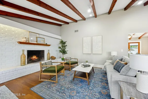 a living room with furniture a rug and a fireplace