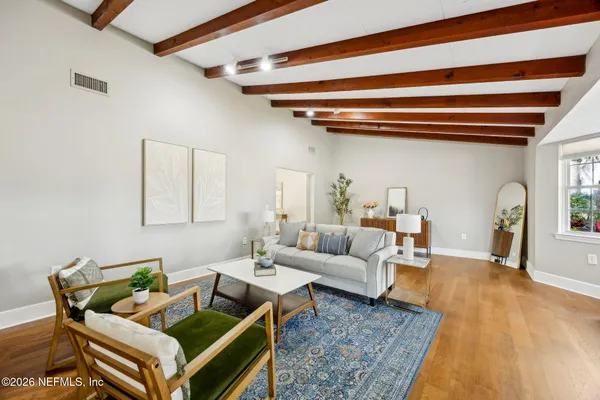 a living room with furniture and a rug
