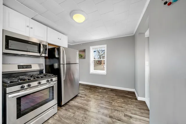 a kitchen with stainless steel appliances a refrigerator stove and microwave