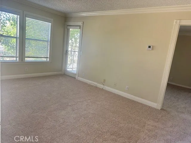 an empty room with windows and closet