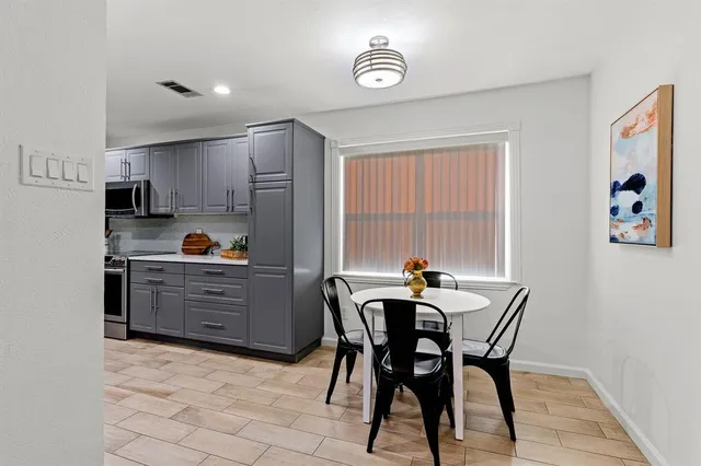 a kitchen with a table and chairs in it