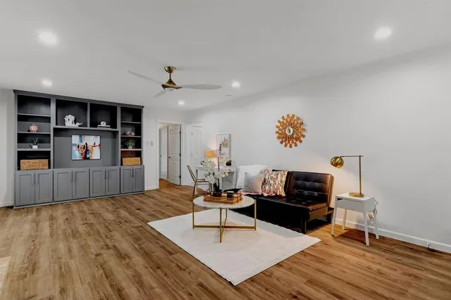 a living room with furniture and wooden floor