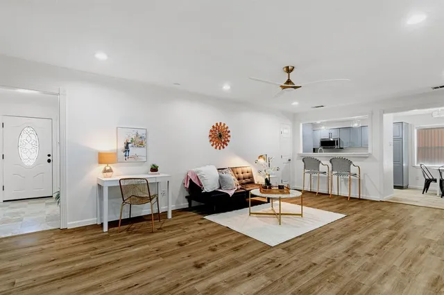 a living room with fireplace furniture and a wooden floor