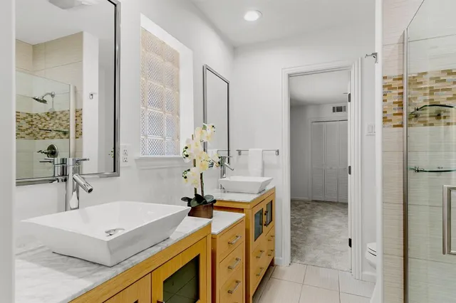 a bathroom with a sink a granite counter and a mirror