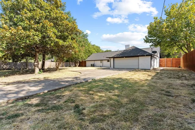 a house that has a tree in front of it