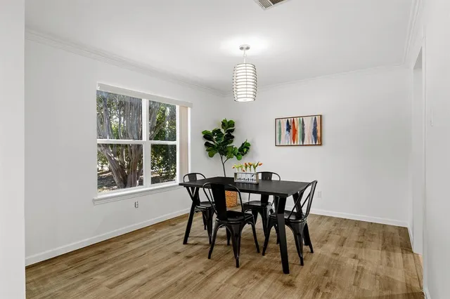a view of a dining room with furniture and window