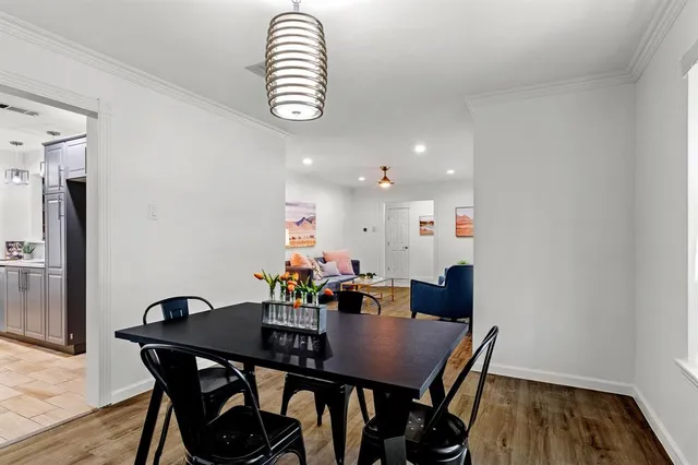 a view of a dining room with furniture and wooden floor