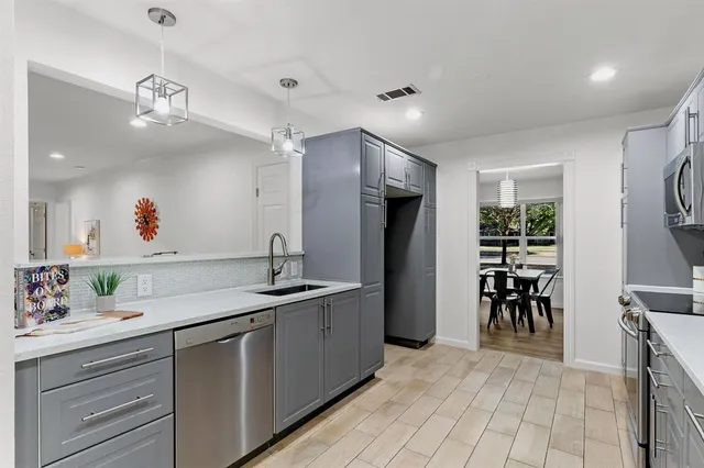 a kitchen with a sink appliances and cabinets