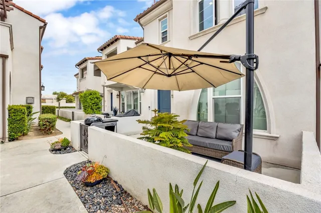 a view of a patio with couches and potted plants