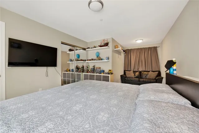 a bathroom with a sink a toilet a mirror a vanity and shower