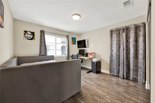a view of a bedroom with furniture and workspace
