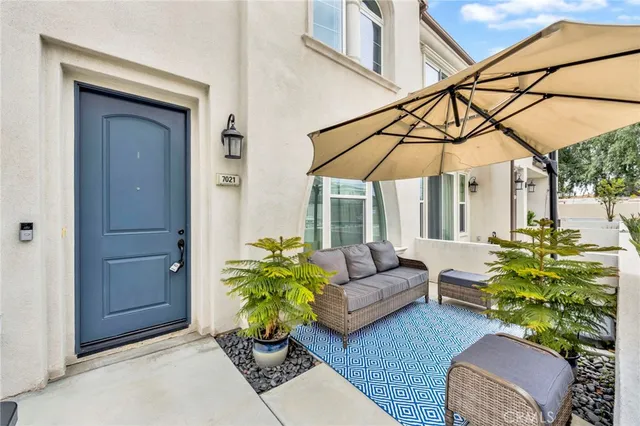 a view of a dining room with furniture and a chandelier