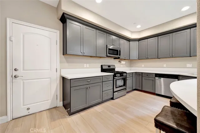 a kitchen with stainless steel appliances granite countertop a sink counter space cabinets and a large window