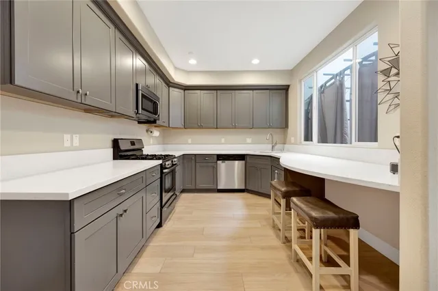 a kitchen with stainless steel appliances a sink and a stove