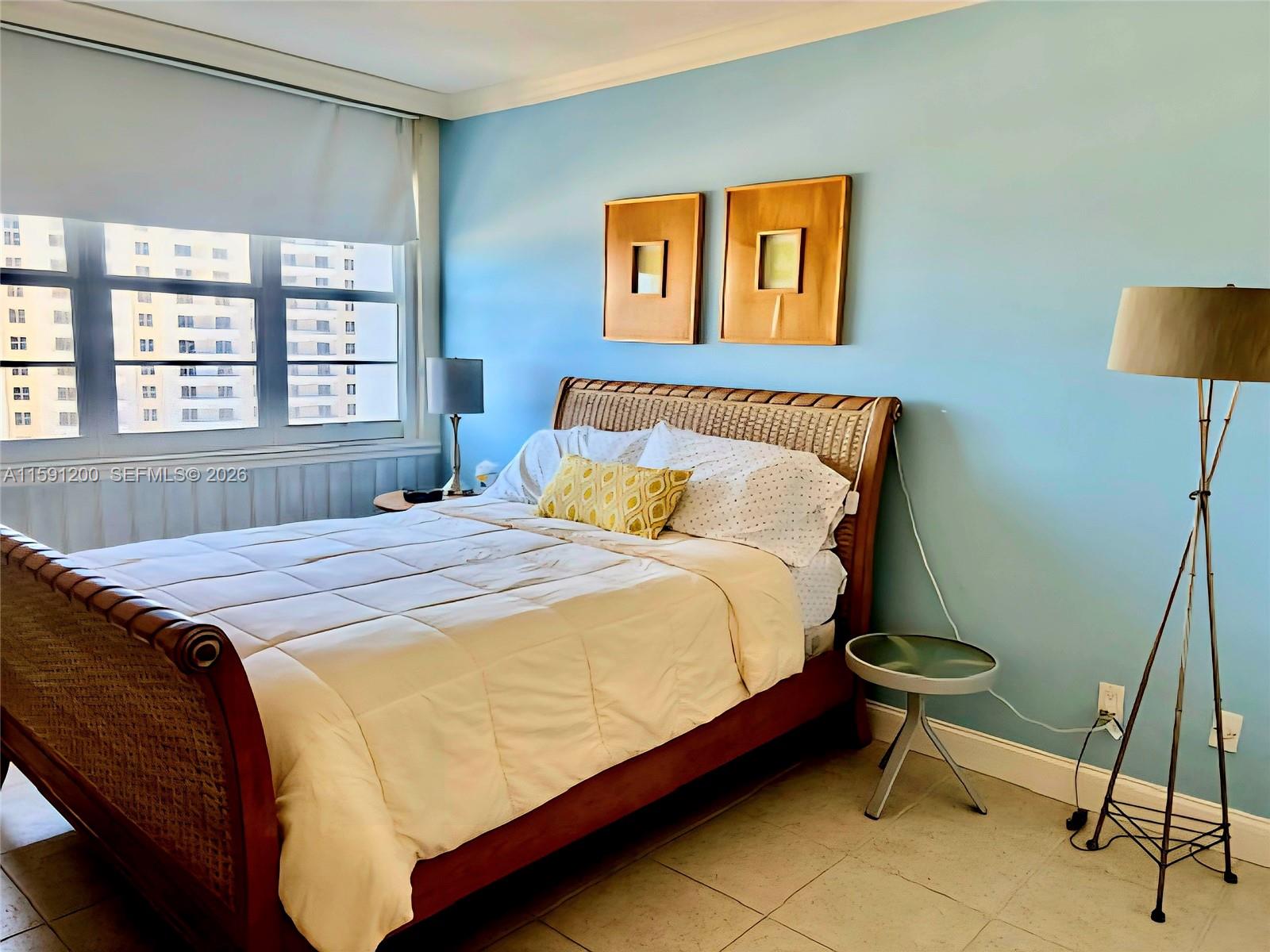 100 Lincoln Road, Unit 1434 Miami Beach, FL 33139 - Photo 5 of 29 a bed sitting in a bedroom next to a window