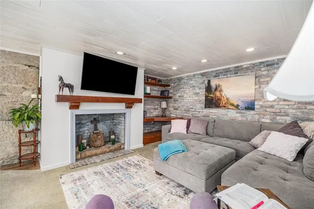 a view of a livingroom with furniture and a fireplace