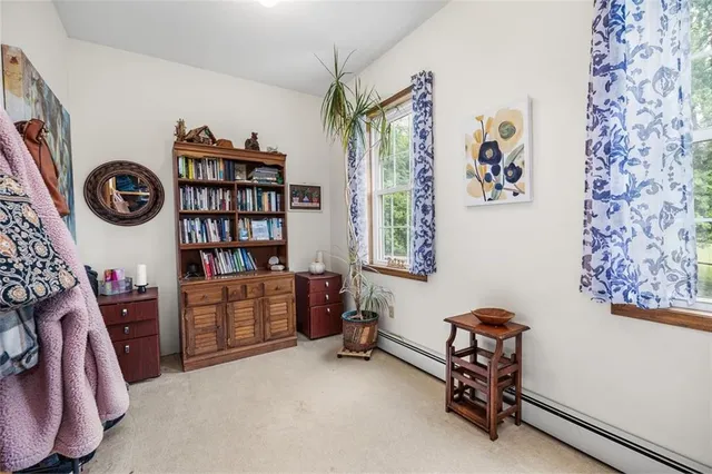 a spacious bedroom with a bed and a chandelier