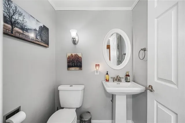 a bathroom with a glass shower door and a window