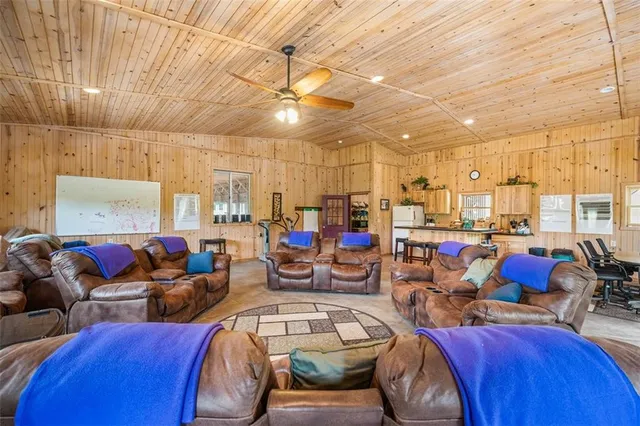 an aerial view of residential houses with outdoor space and trees